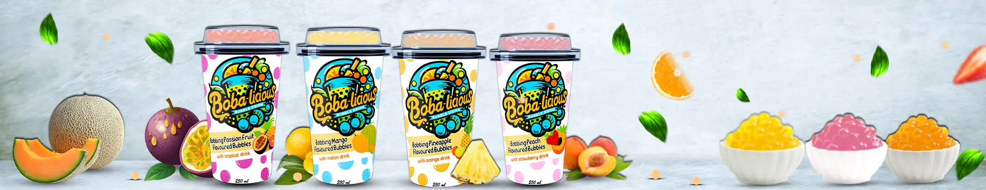 Colorful Bobalicious bubble tea cups with tropical fruits and popping boba on a light backdrop.